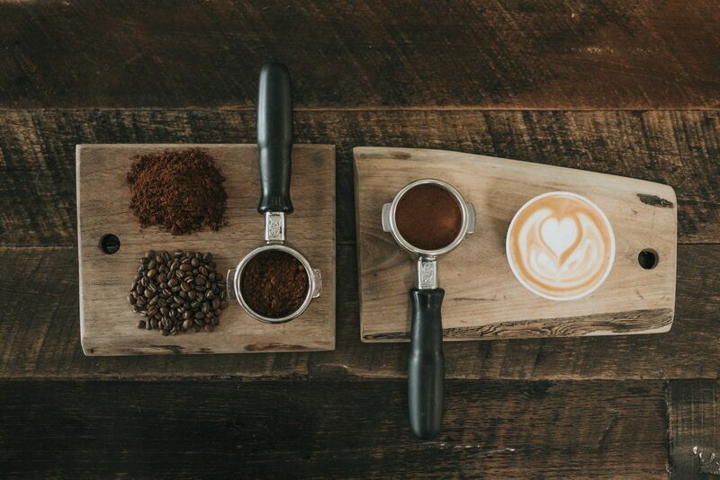 Beans and Filled Cups of Espresso on Wooden Board