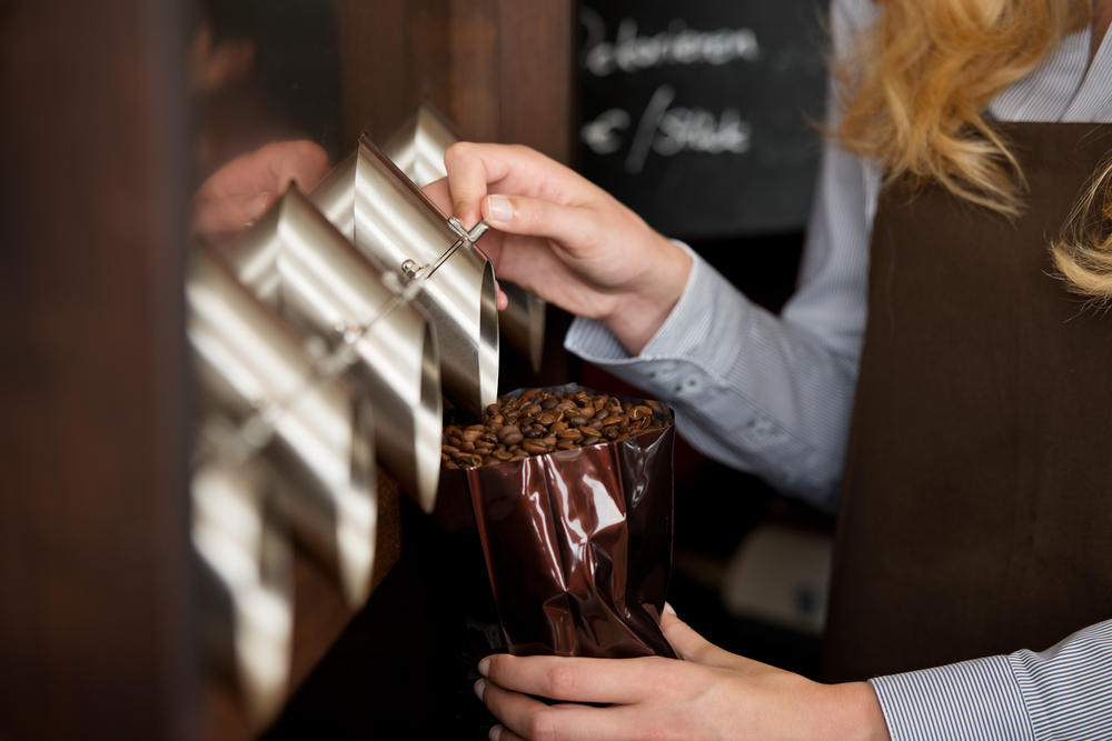 Saleswoman,Filling,Coffee,Beans,In,A,Bag