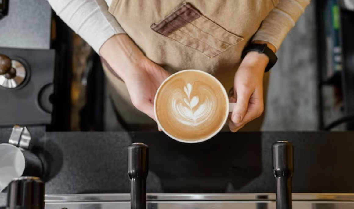 top-view-female-barista-holding-cup-coffee